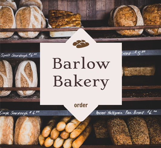 Bakery shelf with bread and a white badge with blask text on top